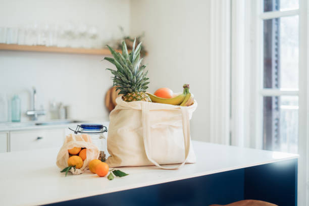 Shopping bag with vegetables and fruits on coutertop